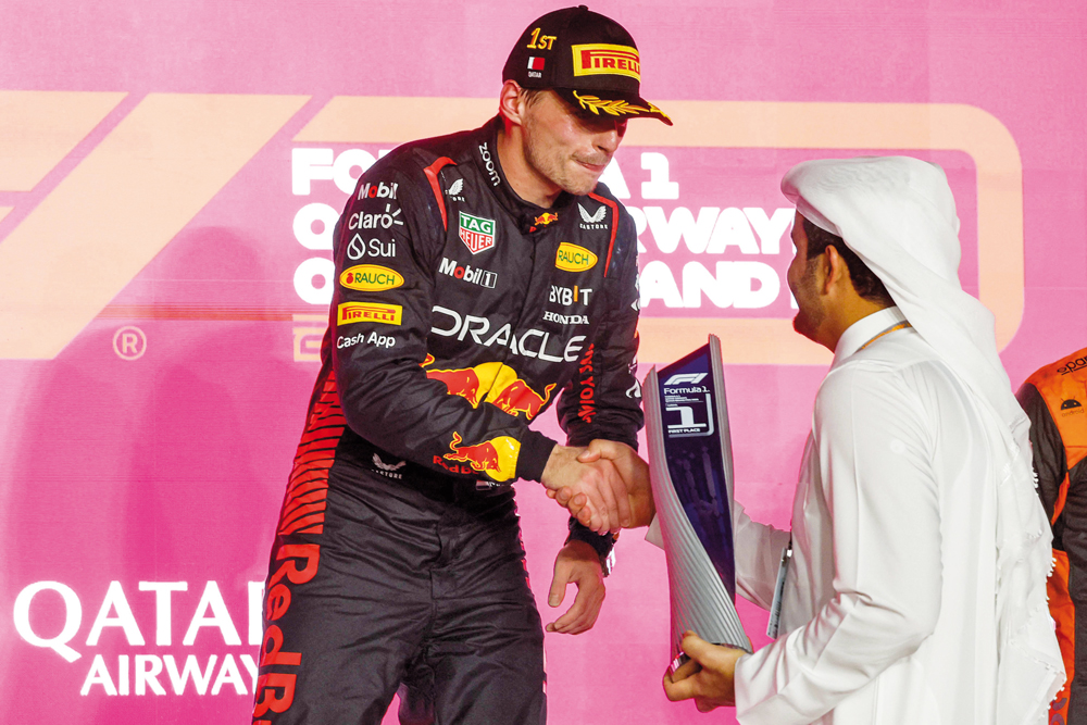 Qatar Olympic Committee President H E Sheikh Joaan bin Hamad Al Thani presents the winner's trophy to Red Bull Racing’s Dutch driver Max Verstappen following the Formula 1 Qatar Airways Qatar Grand Prix 2023, at the Lusail International Circuit, yesterday. AFP