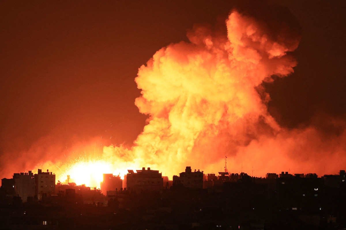 Explosions illuminate the sky during Israeli strikes on Gaza City yesterday. 