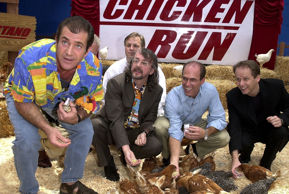 (Files) US actor Mel Gibson (L) feeds Chickens at the premiere of new British animated film 