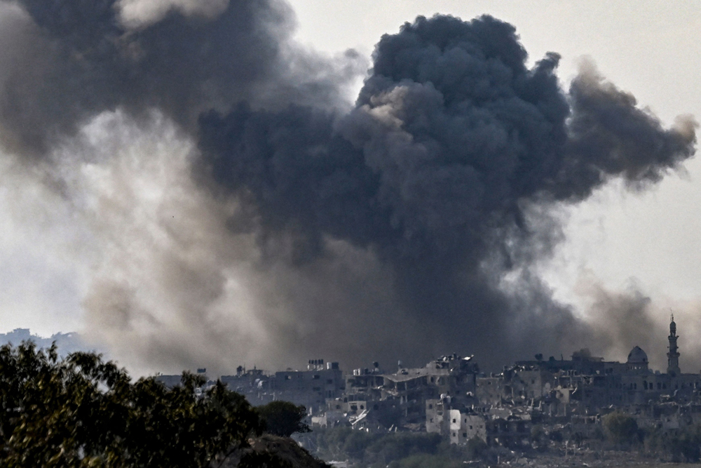 Smoke plumes rising above buildings during an Israeli strike on the Gaza Strip yesterday.