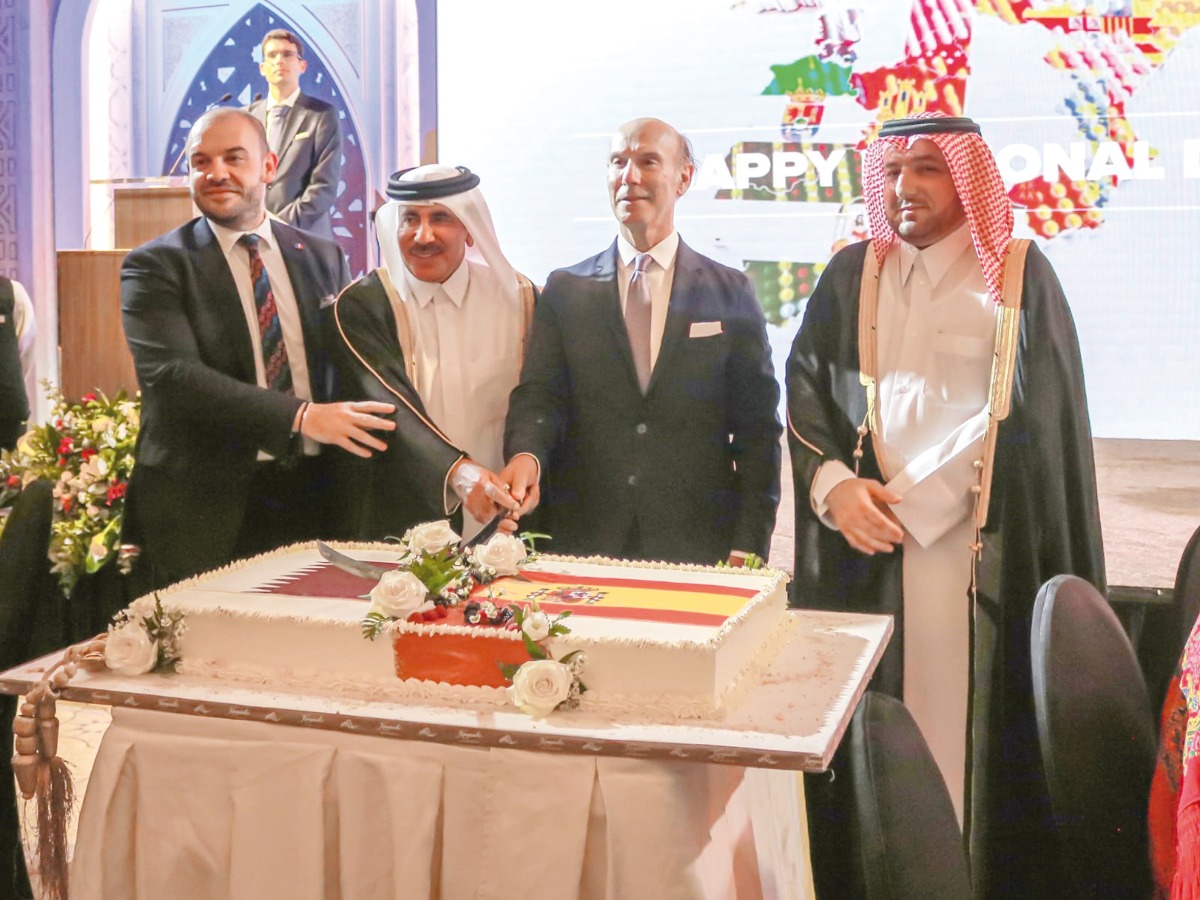 Minister of Transport H E Jassim Saif Ahmed Al Sulaiti (second left); Ambassador of Spain H E Javier Carbajosa (second right); Ambassador of the EU to Qatar H E Dr. Cristian Tudor (left); and Director of the Protocol Department at MoFA, Ambassador Ibrahim Yousif Abdullah Fakhro cut the ceremonial cake during the Spanish National Day celebration. 