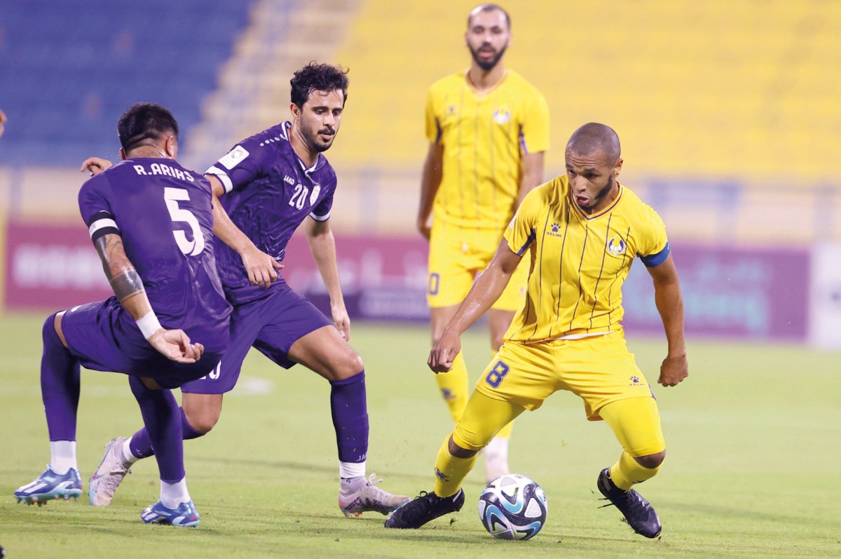 Al Gharafa's Yacine Brahimi (right) controls the ball.