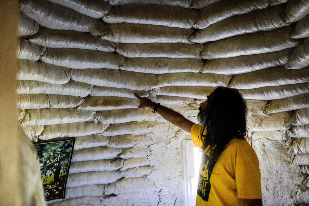 Dimche Ackov shows his makeshift home constructed from entirely locally-sourced supplies, near the town of Veles, in central North Macedonia on October 7, 2023. (Photo by Robert Atanasovski / AFP)