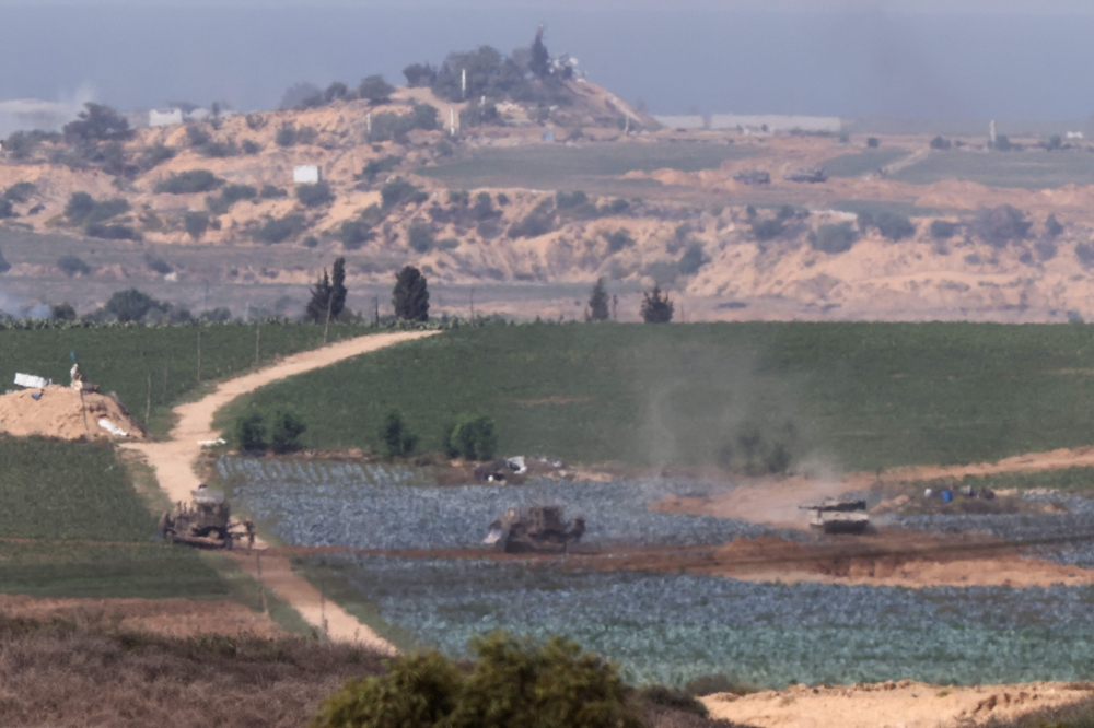 Israeli tanks and bulldozers positioned in the north of the Gaza Strip, on October 30, 2023. (Photo by Jack Guez / AFP)