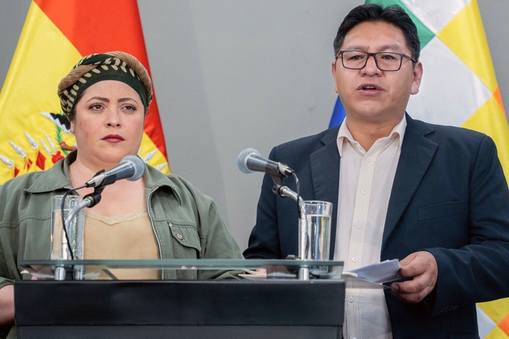 Bolivia's deputy Foreign Minister Freddy Mamani (R) speaks next to the minister of the presidency Maria Nela Prada, during the press conference on October 31, 2023. (Photo by Handout / Bolivia's Foreign Ministry / AFP) 