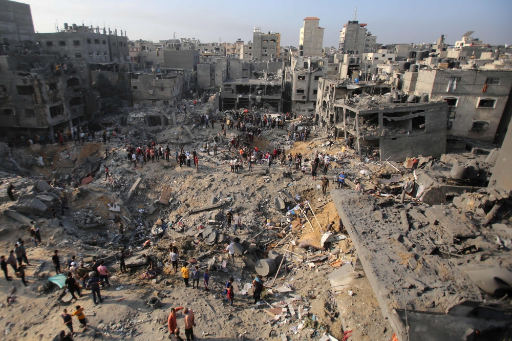 Palestinians check the destruction in the aftermath of an Israeli strike in the Jabalia camp for Palestinian refugees in the Gaza Strip, on November 1, 2023. (Photo by Bashar Taleb / AFP)
