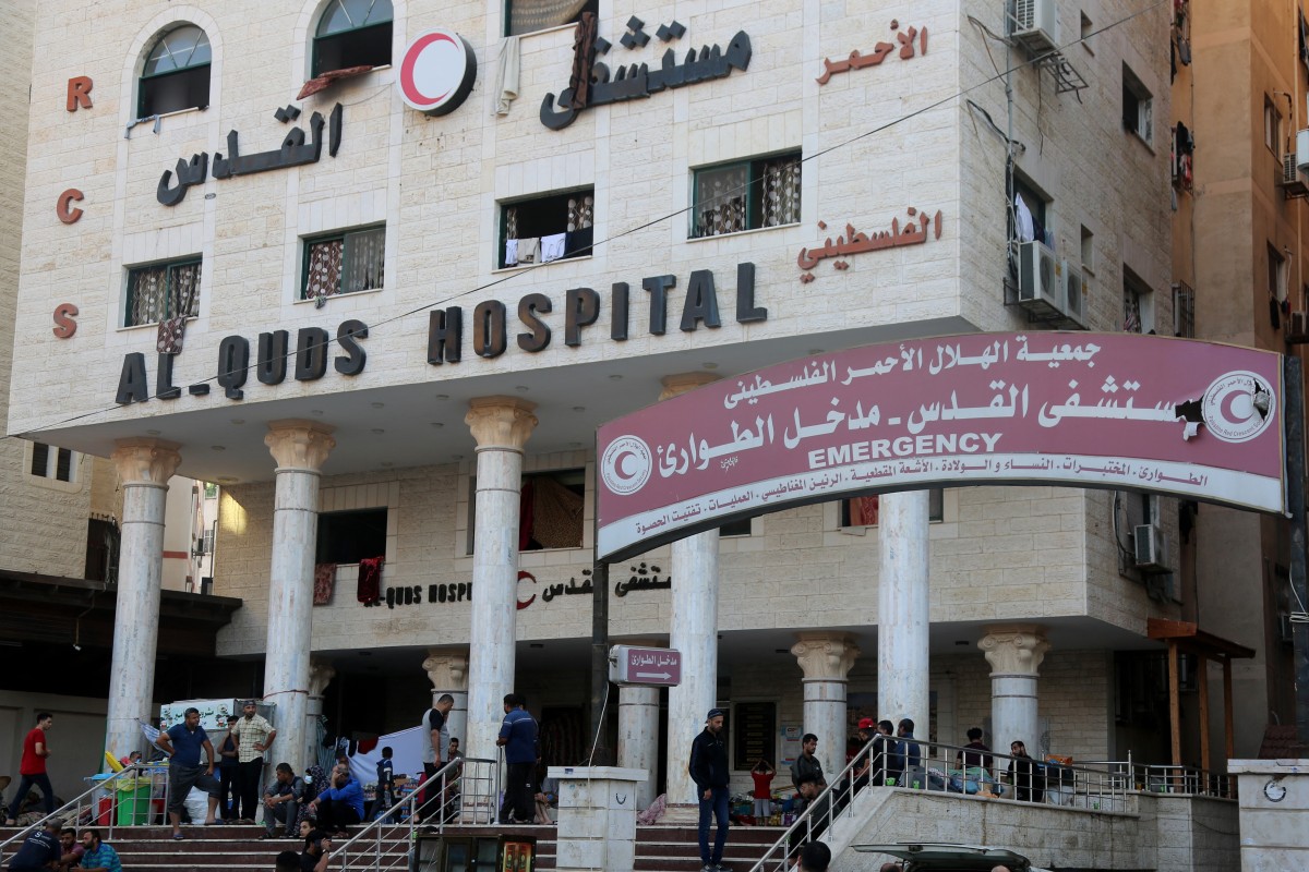 People wait outside Gaza City's Al-Quds Hospital on October 29, 2023. (Photo by Khoder al-Zaanoun / AFP)