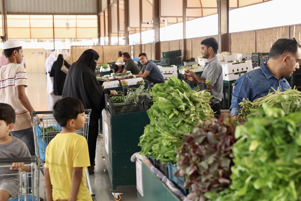 Customers buying vegetables at Al Mazrouah seasonal vegetable market. Pic: Ahmed Barakat