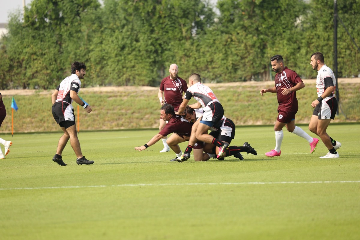 A Qatar player is being tackled by Jordan players during their match on Day 1 of the Asia Rugby Sevens Trophy tournament.