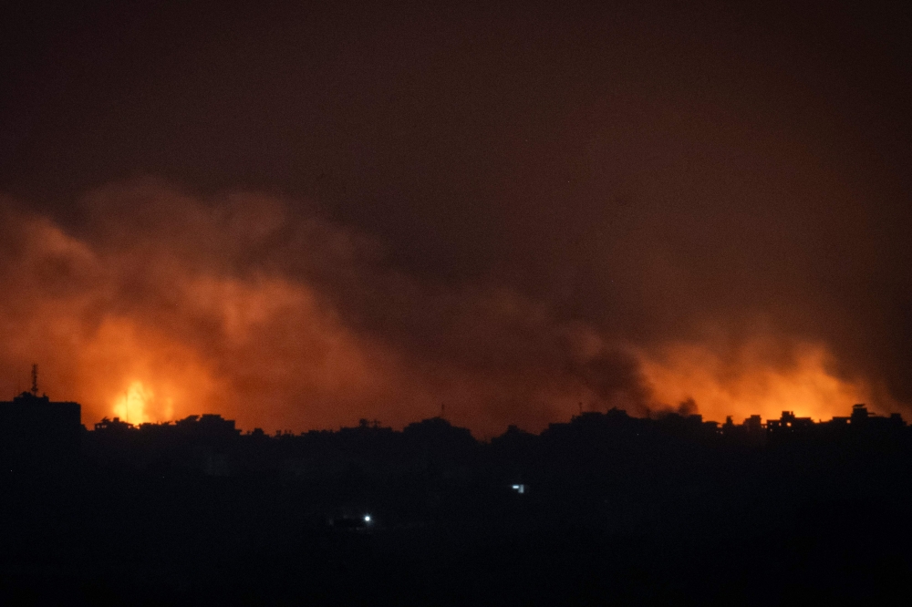 A picture taken from Sderot along the border with the Gaza Strip shows smoke and fire rising over the Palestinian enclave during an Israeli strike on November 5, 2023. (Photo by Aris Messinis / AFP)