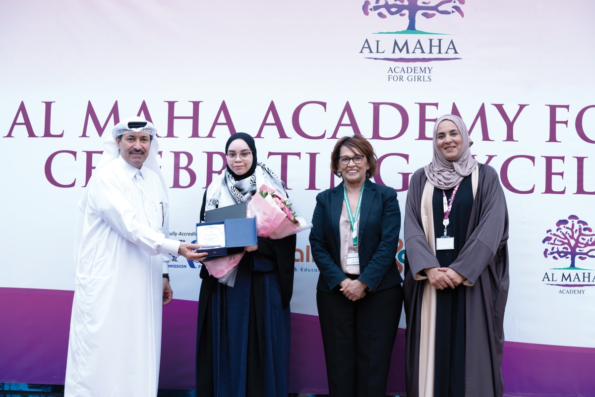 Ta’allum Group officials honouring  students who achieved top grades in external exams.