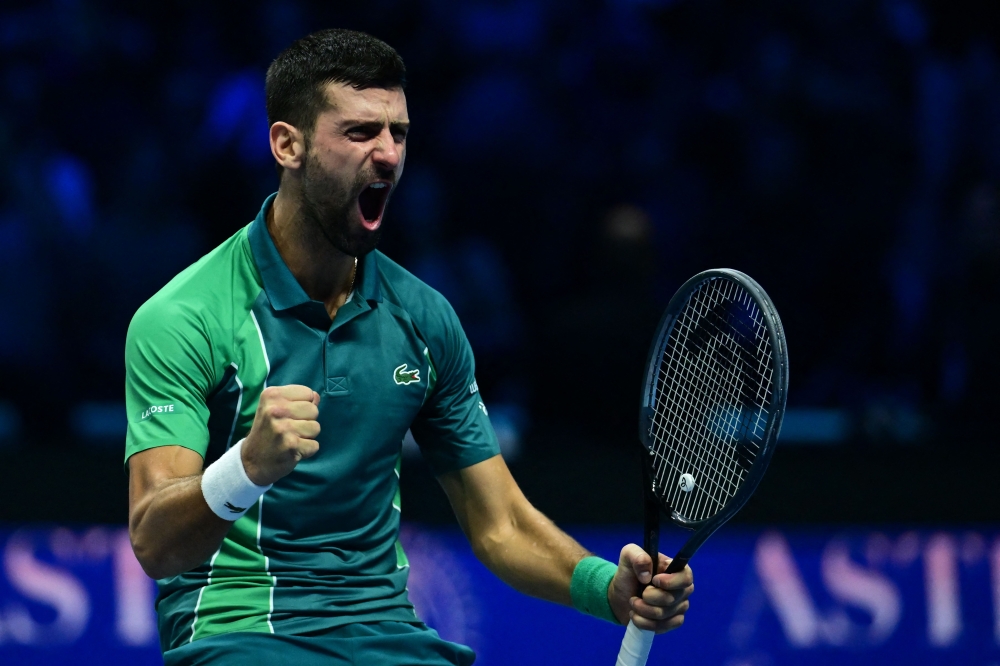 Serbia's Novak Djokovic celebrates after winning the final match against Italy's Jannik Sinner at the ATP Finals tennis tournament in Turin on November 19, 2023.   Photo by Tiziana FABI / AFP