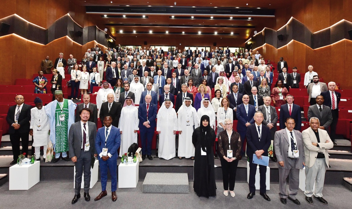 QU President Dr. Omar Al Ansari  (centre, second row) with other participants during a group photo during the opening ceremony of the IAU 2023 Conference.