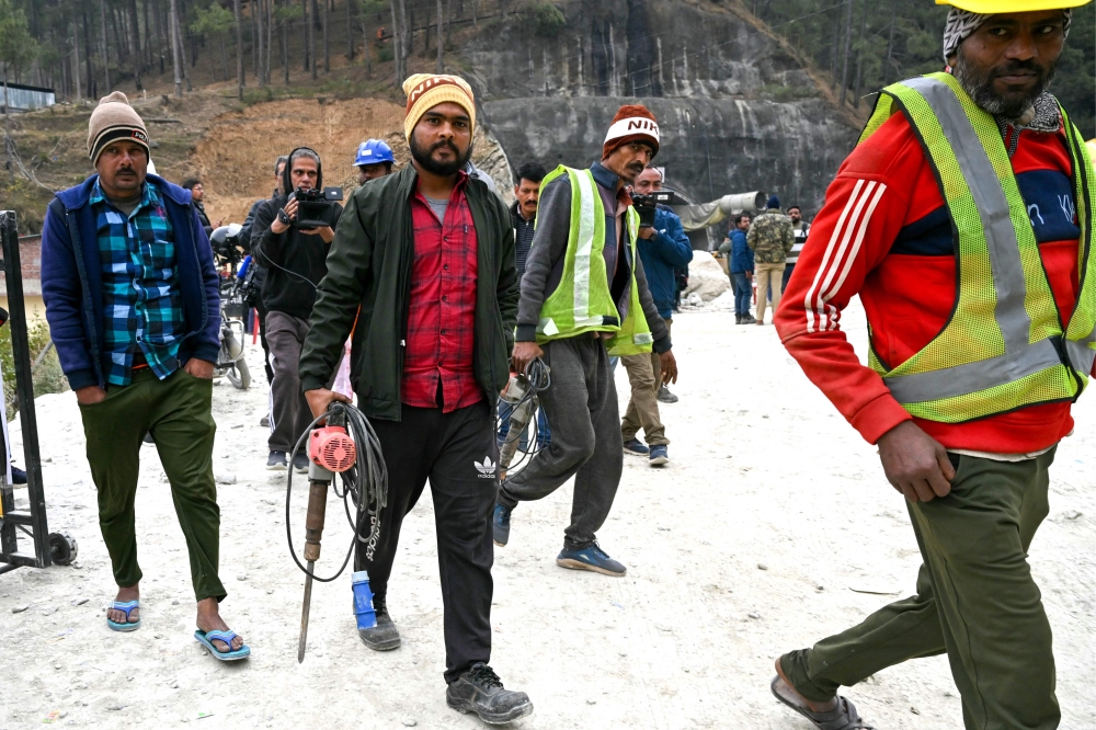 Rescue personnel arrive for manual drilling at the collapsed under construction Silkyara tunnel on November 27, 2023. (Photo by Arun SANKAR / AFP)