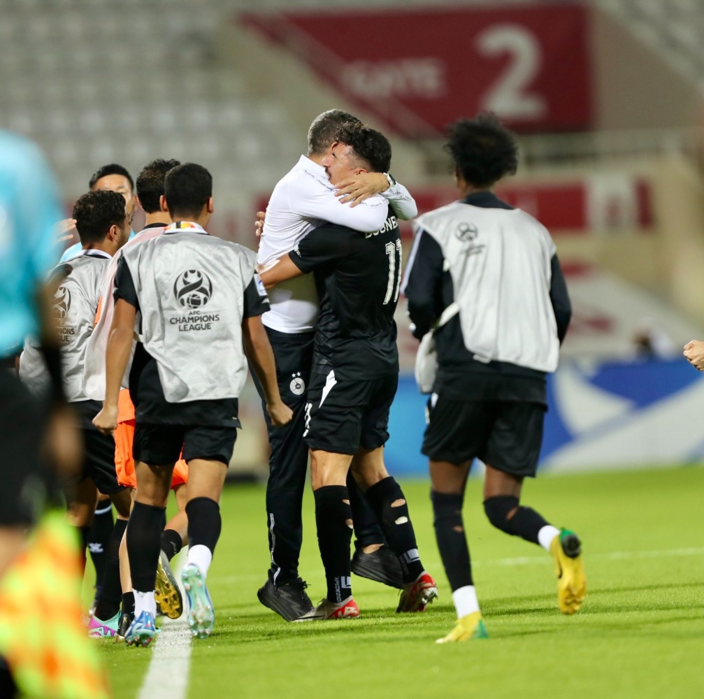 Al Sadd players and officials celebrate their win over Sharjah.