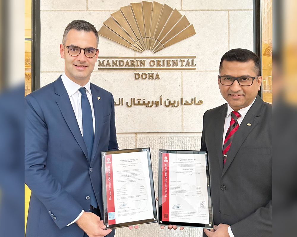 General Manager of Mandarin Oriental, Doha, Thomas Kinsperger (left) and another official with the ISO certification.