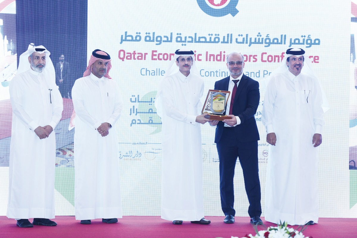 Chairman of the Board of Directors of Dar Al Sharq Group Sheikh Dr Khalid bin Thani Al Thani (centre) honouring Managing Director of Averroes Business Advisory and Services Ahmed Abounahia during the first ‘Qatar Economic Indicators Conference’ organised by Dar Al Sharq, yesterday. CEO of Dar Al Sharq Abdul Latif Abdullah Al Mahmoud (left), Board Member of Qatar International Centre for Conciliation and Arbitration at Qatar Chamber Sheikh Dr. Thani bin Ali bin Saud Al Thani (second left) and Qatar Chamber First Vice-Chairman Mohamed bin Twar Al Kuwari are also seen at the event.