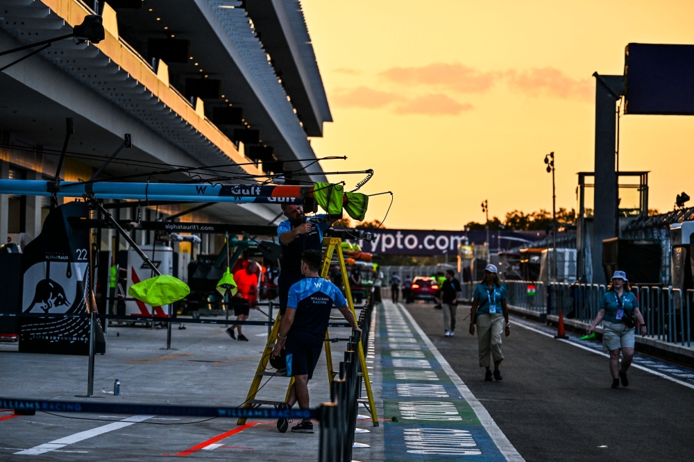 Technicians work on pit lane ahead of the Miami Grand Prix at the Miami International Autodrome in Miami Gardens, Florida, on May 3, 2023. Photo by CHANDAN KHANNA / AFP

