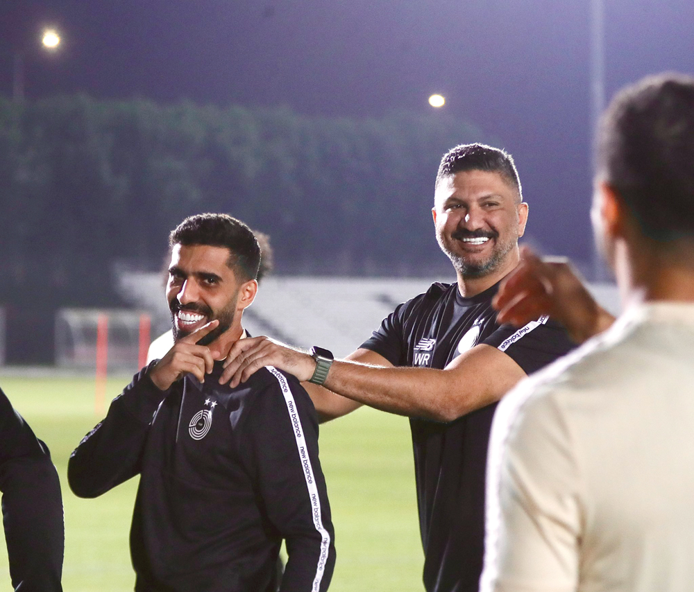 Al Sadd's Hassan Al Haydos (left) and coach Wesam Rizik.