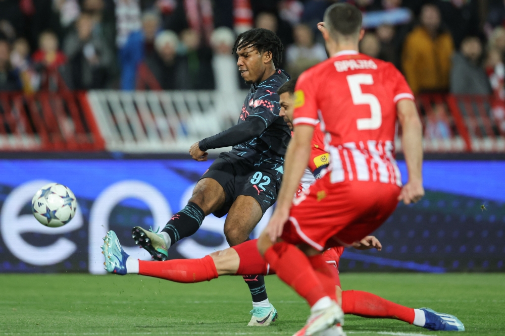 Manchester City's English midfielder Micah Hamilton (left) scores his team's first goal during the UEFA Champions League Group G day 6 group stage football match between Crvena Zvezda (Red Star Belgrade) and Manchester City at the Red Star stadium in Belgrade, on December 13, 2023. (Photo by PEDJA MILOSAVLJEVIC / AFP)
