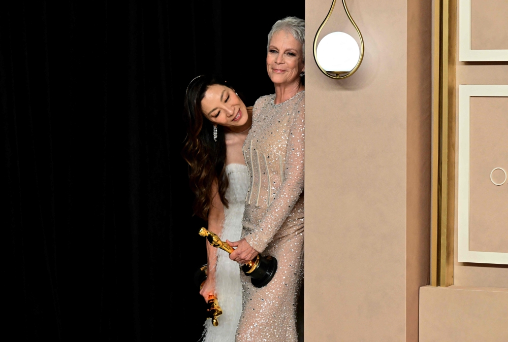 File: Best Actress in a Supporting Role winner US actress Jamie Lee Curtis (right) and Best Actress in a Leading Role Malaysian actress Michelle Yeoh are pictured in the press room during the 95th Annual Academy Awards at the Dolby Theatre in Hollywood, California on March 12, 2023. (Photo by Frederic J Brown / AFP)