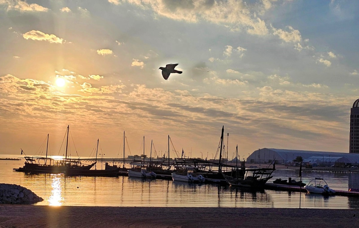 Sunrise rays glisten as they reflect off surface of the water at Katara's beach front, with a lone bird encased in the sun's warm glow gliding across the frame. (Photo by Marivie Alabanza / The Peninsula)