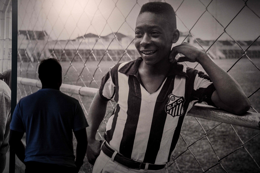 A visitor looks at a picture of Brazil's football legend Edson Arantes do Nascimento 'Pele', exhibited at the Pele Museum, in Santos, Brazil, on December 27, 2022. Photo by NELSON ALMEIDA / AFP