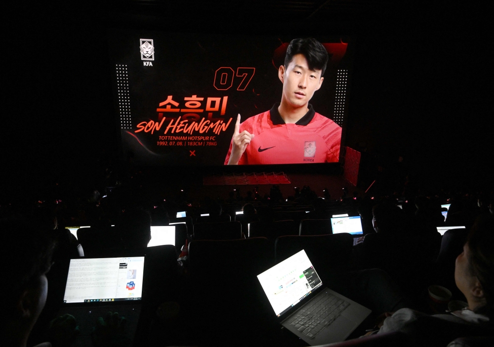 South Korea's national football team player Son Heung-min is seen on a screen during a press conference to announce the South Korean squad for the Asian Cup in Seoul on December 28, 2023. (Photo by Jung Yeon-je / AFP)