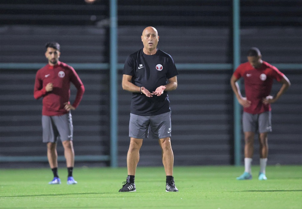 Qatar coach Marquez Lopez supervises team's training session. 

