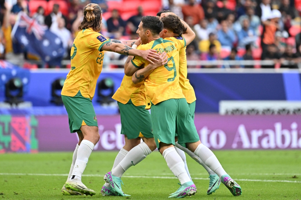 Australia's defender #05 Jordan Bos (C) celebrates with teammates after scoring his team's second goal on January 13, 2024. (Photo by Hector Retamal / AFP)
