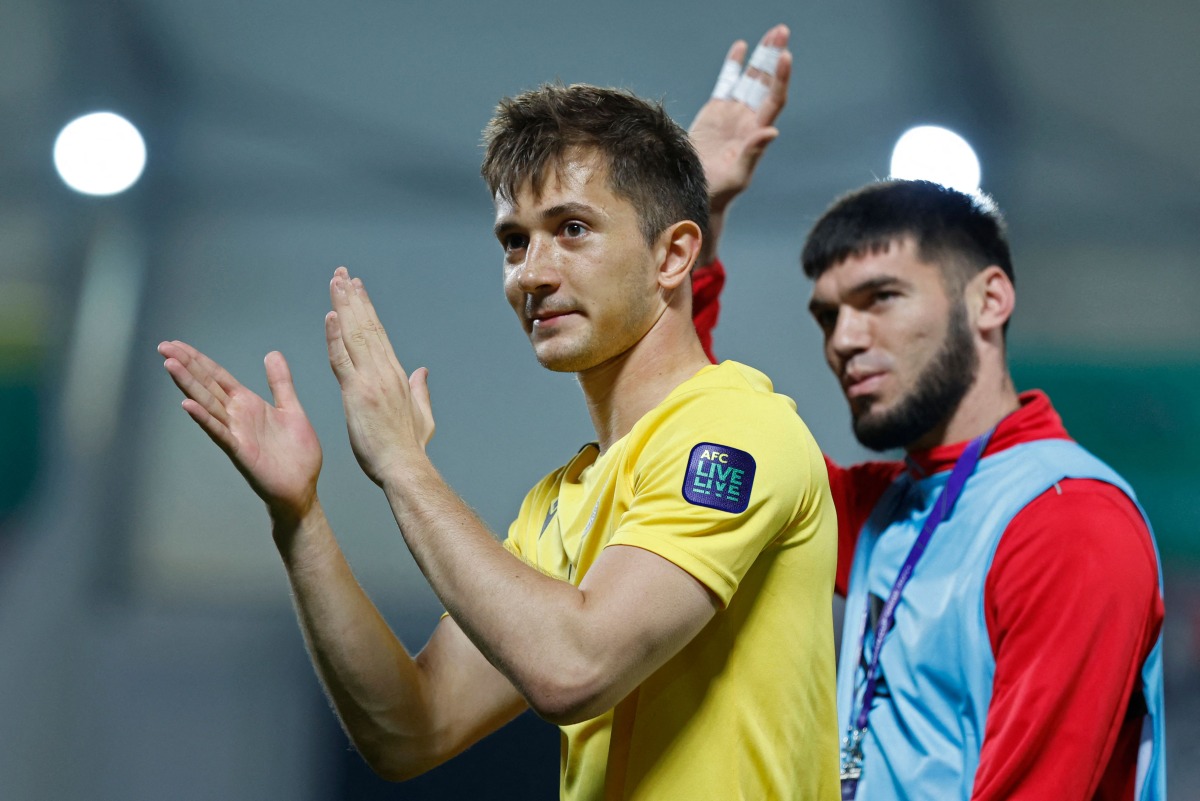 Tajikistan’s goalkeeper Rustam Yatimov salutes the fans after the end of the match against China. AFP