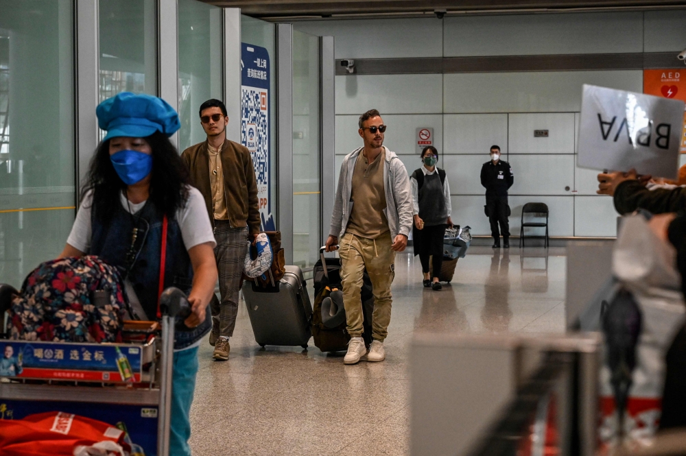 File photo of Passengers walk through the arrivals hall for international flights at the Capital International Airport in Beijing on March 14, 2023. Photo by Jade GAO / AFP

