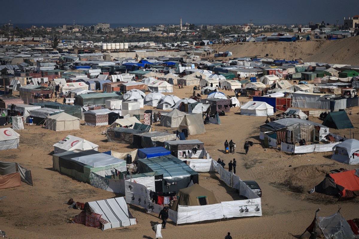 Displaced Palestinians gather at a makeshift camp on the Egyptian border, west of Rafah in the southern Gaza Strip on January 14, 2024. Photo by AFP