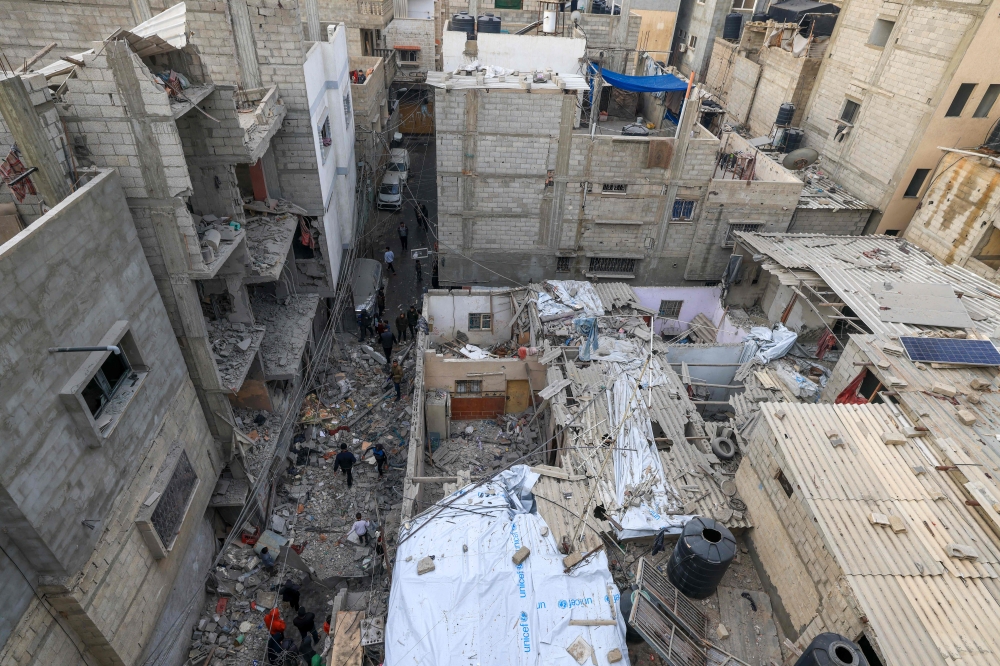 People inspect the damage following Israeli bombardment in Rafah, on the southern Gaza Strip, on January 17, 2024. (Photo by AFP)