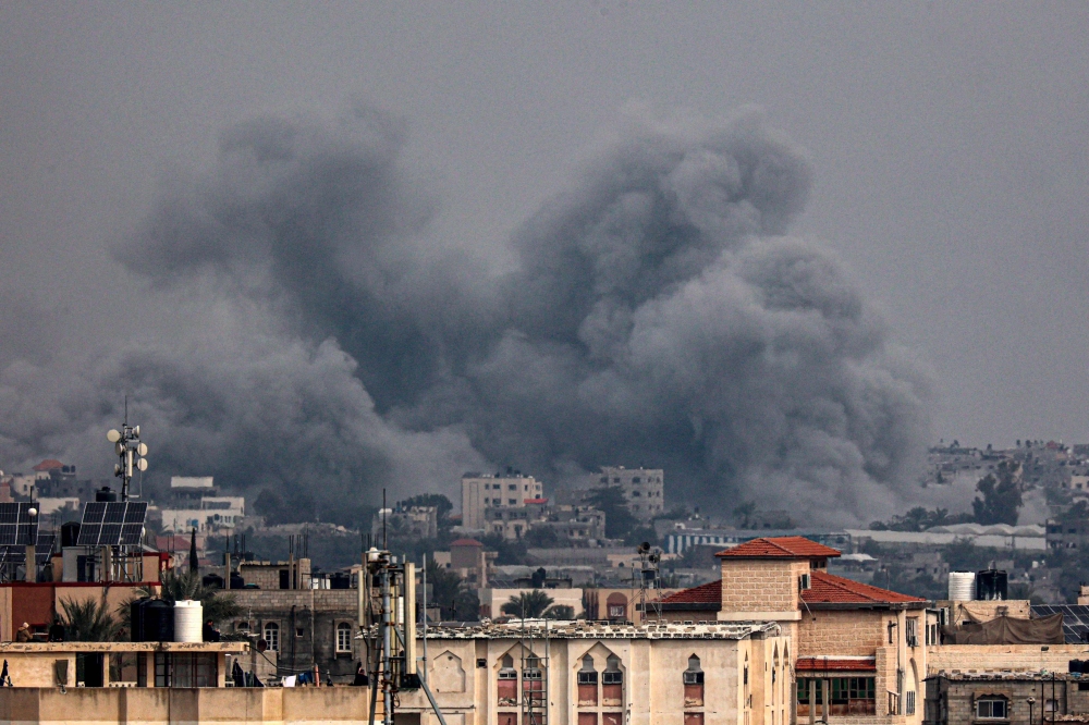 This picture taken from Rafah shows smoke billowing over Khan Yunis in the southern Gaza Strip on January 17, 2024. (Photo by AFP)