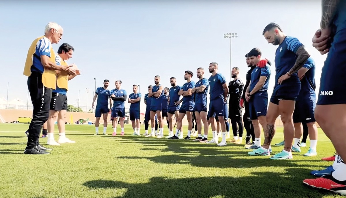 Syria coach Hector Cuper speaks to his team.