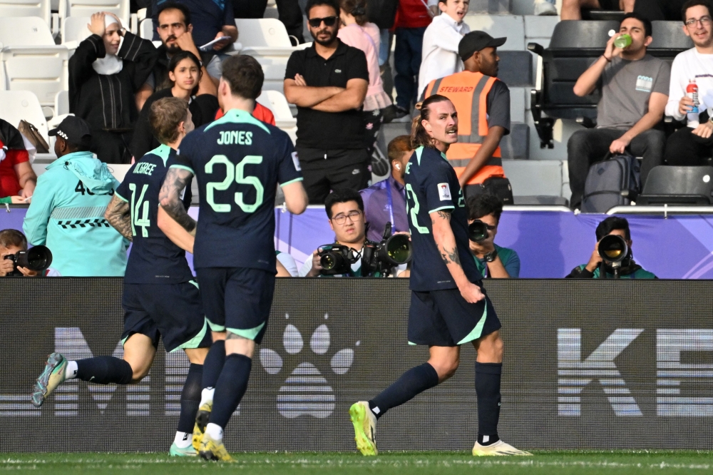 Australia's midfielder #22 Jackson Irvine celebrates after scoring his team's first goal during the Qatar 2023 AFC Asian Cup Group B football match between Syria and Australia at the Jassim bin Hamad Stadium in Doha on January 18, 2024. (Photo by HECTOR RETAMAL / AFP)
