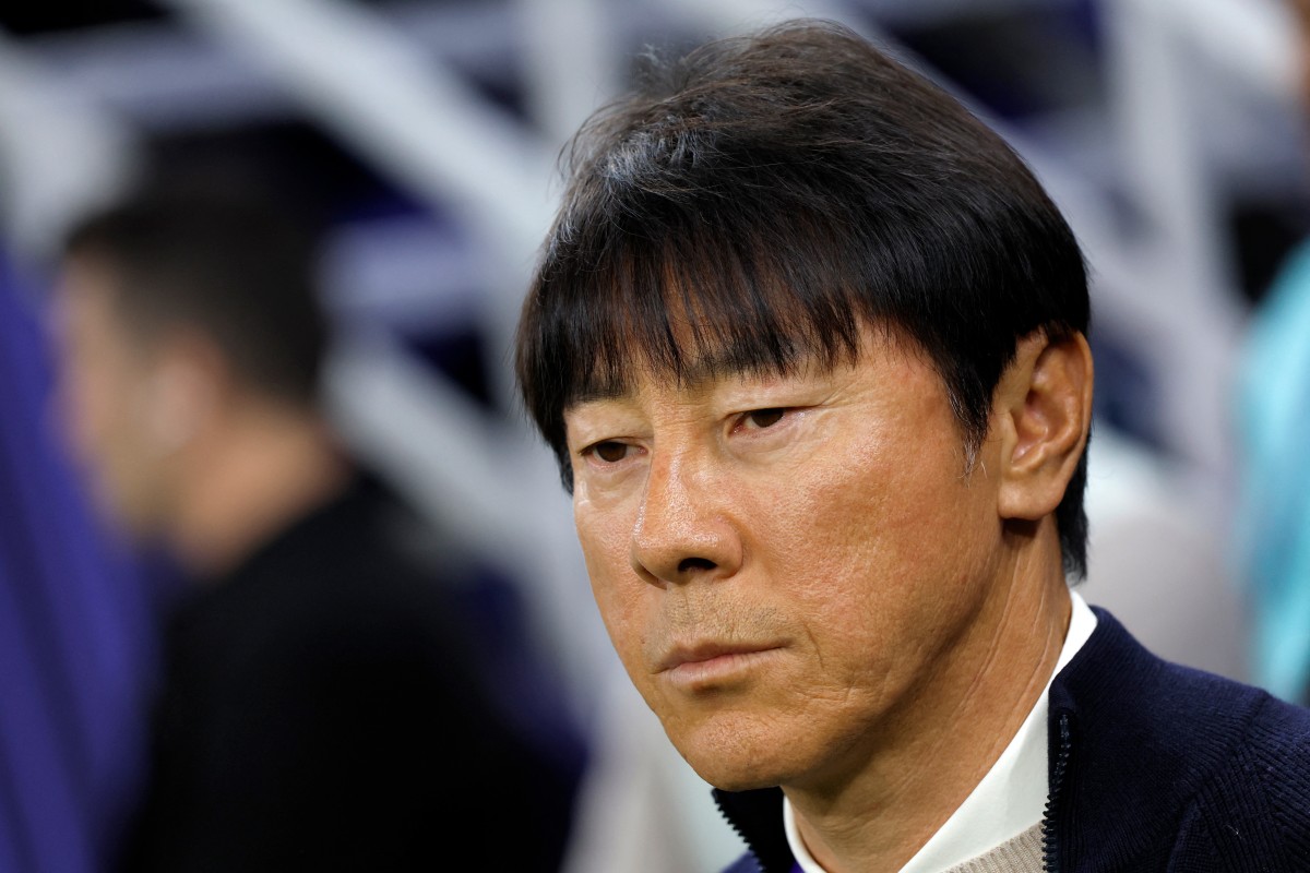 Indonesia's South Korean coach Shin Tae-Yong watches the Qatar 2023 AFC Asian Cup Group D football match between Indonesia and Iraq at the Ahmad bin Ali Stadium in Al-Rayyan, west of Doha on January 15, 2024. (Photo by KARIM JAAFAR / AFP)
