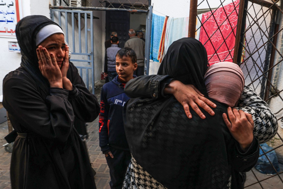 Palestinians mourn the death of loved ones following Israeli bombardment on January 18, 2024, in Rafah in the southern Gaza Strip. Photo by AFP