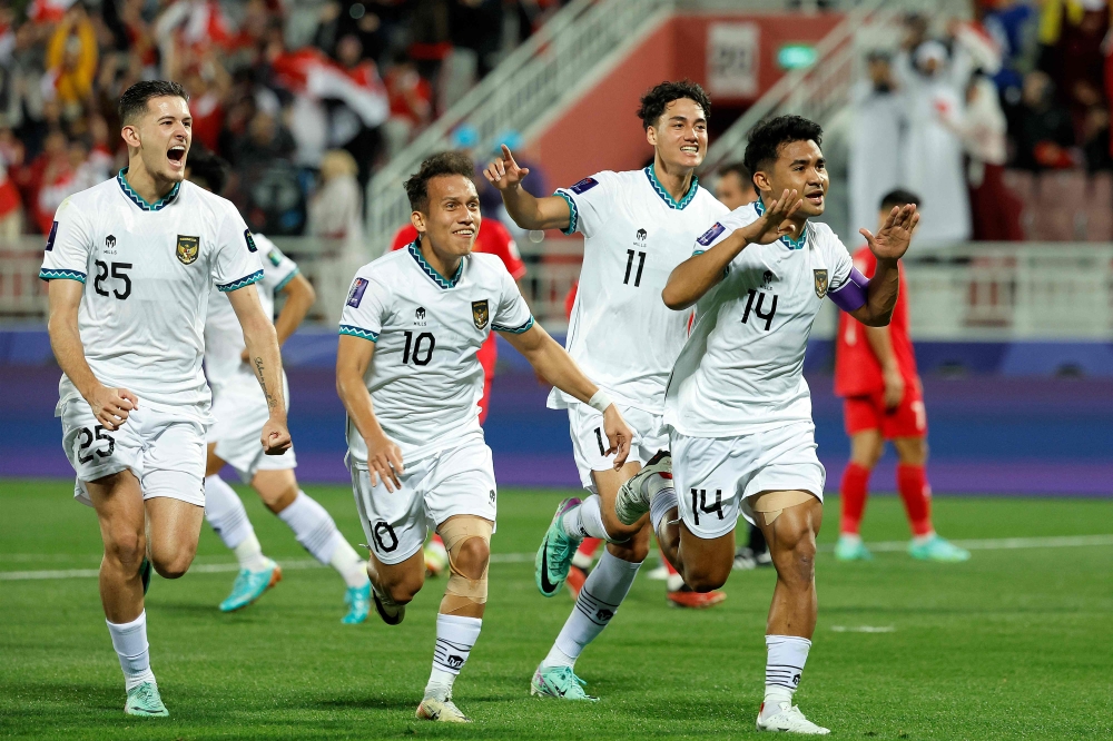 Indonesia's defender #14 Asnawi Mangkualam celebrates after scoring his team's first goal from the penalty spot during the Qatar 2023 AFC Asian Cup Group D football match between Vietnam and Indonesia at the Abdullah bin Khalifa Stadium in Doha on January 19, 2024. (Photo by Karim Jaafar / AFP)