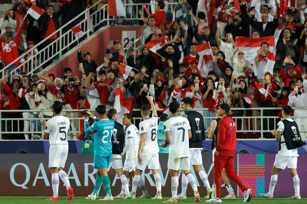 Indonesia's players wave to the fans at the end of the Qatar 2023 AFC Asian Cup Group D football match between Vietnam and Indonesia at the Abdullah bin Khalifa Stadium in Doha on January 19, 2024. (Photo by Karim Jaafar / AFP)