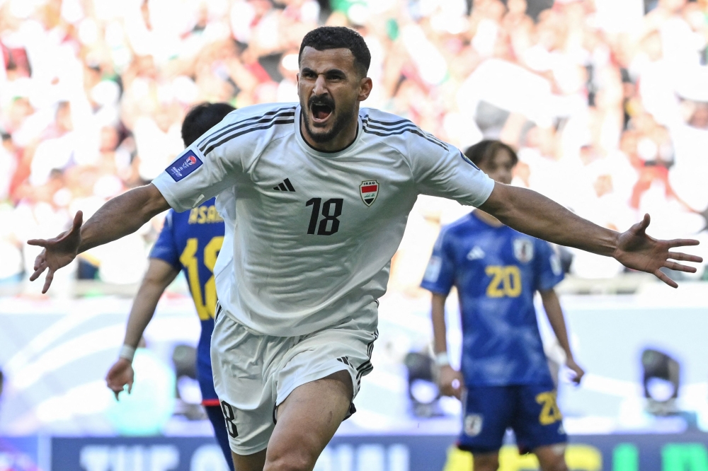 Iraq's forward #18 Aymen Hussein celebrates after scoring his team's first goal during the Qatar 2023 AFC Asian Cup Group D football match between Iraq and Japan at the Education City Stadium in Al-Rayyan on January 19, 2024. (Photo by Hector Retamal / AFP)