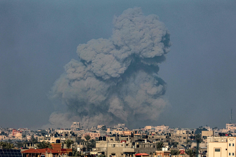 A picture taken from Rafah shows smoke billowing over Khan Yunis in the southern Gaza Strip during Israeli bombardment on January 19, 2024. (Photo by AFP)