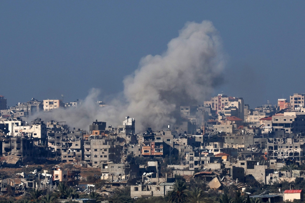 A picture taken from southern Israel on the border with the Gaza Strip shows smoke billowing over the Palestinian territory during Israeli bombardment on January 19, 2024. (Photo by JACK GUEZ / AFP)
