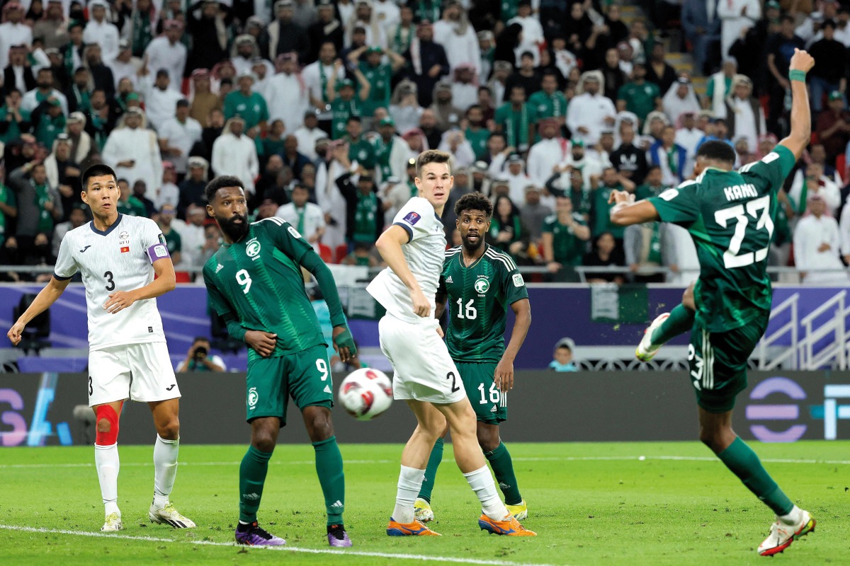 Saudi Arabia’s midfielder Mohamed Kanno (right) shoots to score his team’s first goal against Kyrgyzstan. AFP