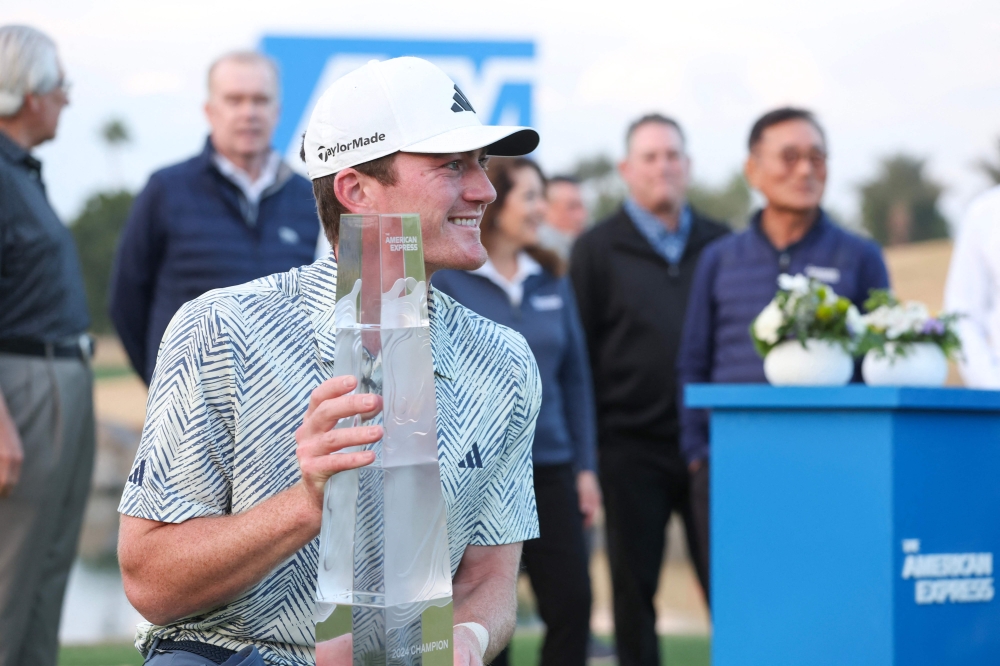 Nick Dunlap of the US poses for a photo with the trophy after winning The American Express at Pete Dye Stadium Course on January 21, 2024 in La Quinta, California. Sean M. Haffey/Getty Images/AFP 