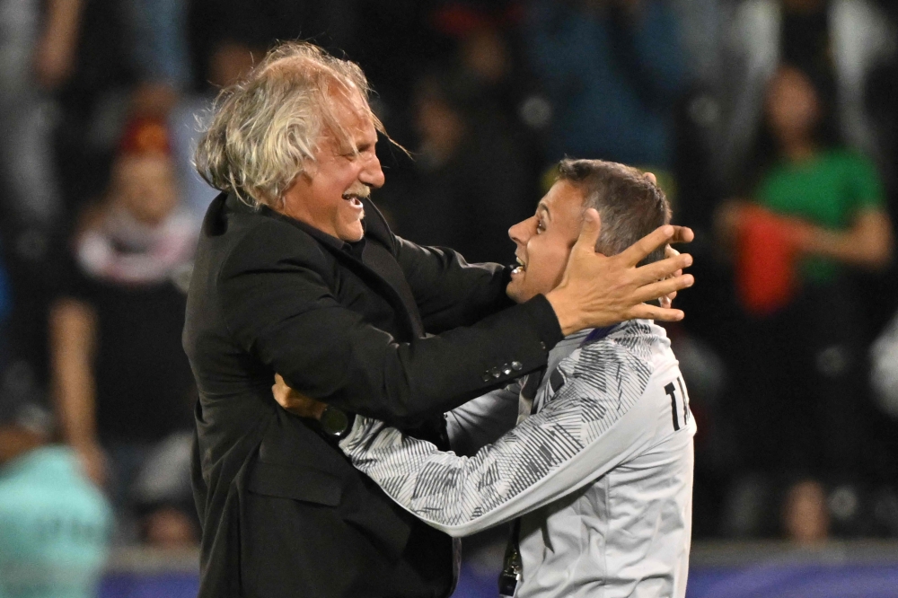 Tajikistan's Croatian coach Petar Segrt celebrates with his assistant after the Qatar 2023 AFC Asian Cup Group A football match between Tajikistan and Lebanon at the Jassim bin Hamad Stadium in Doha on January 22, 2024. (Photo by HECTOR RETAMAL / AFP)