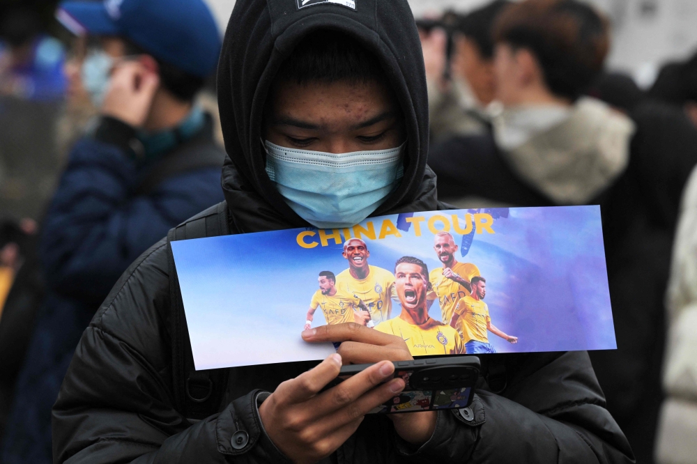 Fans of Portuguese footballer Cristiano Ronaldo gather prior to an Al-Nassr training session at the Universiade Sports Center in Shenzhen, Guangdong Province, on January 23, 2024. (Photo by Pedro PARDO / AFP)