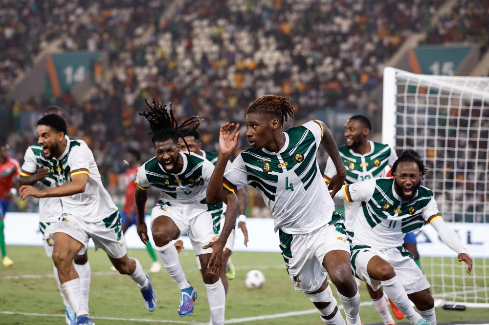 Cameroon's defender #4 Christopher Wooh celebrates scoring his team's third goal during the Africa Cup of Nations (CAN) 2024 group C football match between Gambia and Cameroon at Stade de la Paix in Bouake on January 23, 2024. (Photo by KENZO TRIBOUILLARD / AFP)
