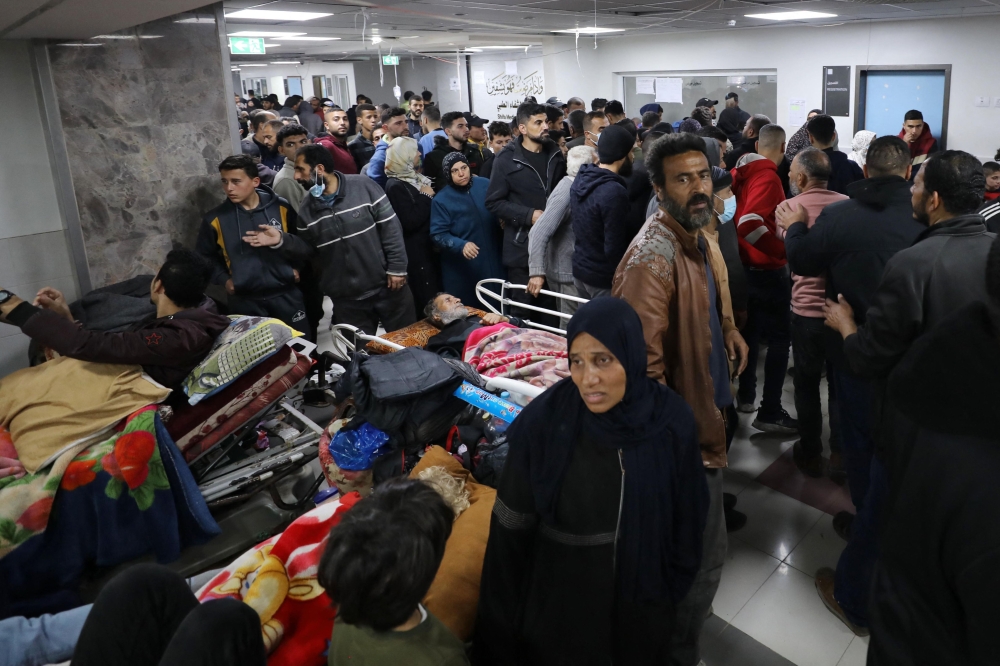 Injured people receive treatment in Gaza City's Al-Shifa hospital on January 25, 2024. (Photo by AFP)